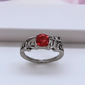 Vintage silver-plated alloy ring featuring a large oval red ruby and hollow carvings