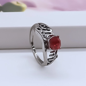 Detailed close-up of retro hollow silver ring featuring a faceted red ruby gemstone
