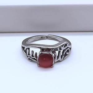 Detailed close-up of retro silver ring with red gemstone and hollow LOVE engraving