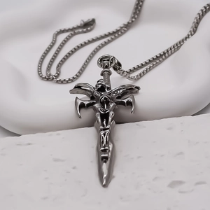 Macro detail of gothic sword pendant with skull handle and square bead chain link