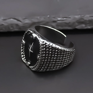 Macro view of vintage punk ring with black oval star motif and textured relief band