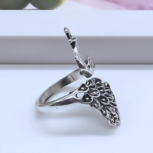 Adjustable silver peacock feather ring with vintage engraved details on a white pedestal