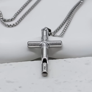 Detail of silver stainless steel cross whistle pendant on square box chain necklace