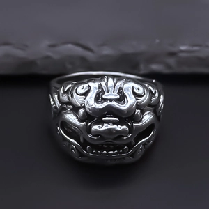 Detailed macro shot of vintage silver lion ring featuring intricate punk style carving