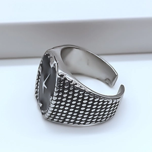 Macro view of vintage silver ring featuring black oval surface and letter K emblem