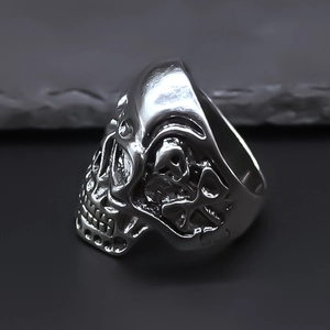 Detailed macro shot of vintage silver skull ring showing intricate gothic metal relief