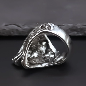 Close-up of wolf king ring showing rugged rock texture and silver vintage finish