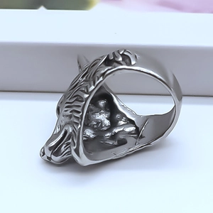 Macro shot of 3D wolf head relief and engraved fur textures on a retro alloy ring