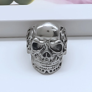 Detailed view of silver skull ring featuring gothic punk carvings and polished finish