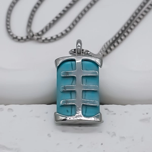 Detailed macro view of vintage turquoise pendant on a delicate silver necklace chain