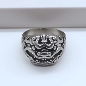 Detailed front view of retro lion head relief on silver-colored stainless steel ring