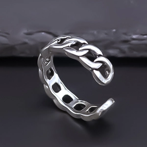 Close-up of vintage silver interlocking Cuban link ring with adjustable open band detail