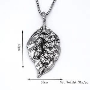 Silver vintage leaf pendant necklace with peanut and coin motifs on box chain