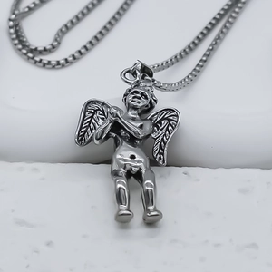 Macro detail of antique silver cupid angel pendant with intricate feather texture on chain