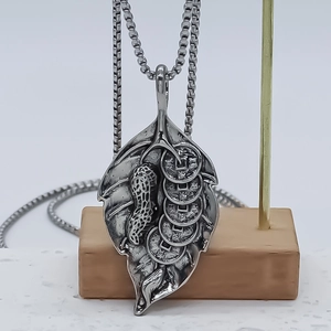 Vintage silver leaf pendant with peanut and coin relief on stainless steel box chain