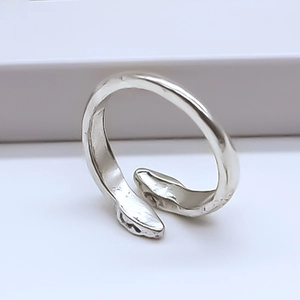Macro shot of silver double snake ring featuring adjustable open band and hammered texture