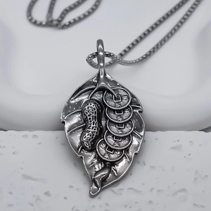 Leaf pendant necklace with peanut and coin motifs in vintage silver stainless steel