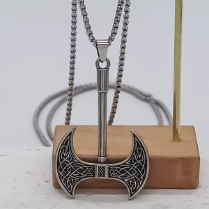 Vintage double-edged Viking axe necklace with Celtic knot patterns on silver box chain