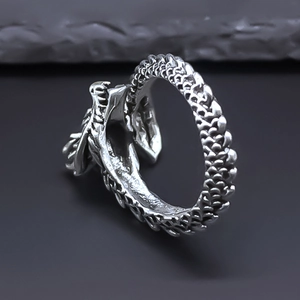 Macro detail of retro dragon ring showing intricate scales and vintage silver finish