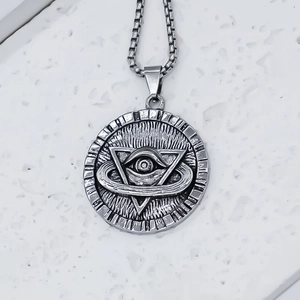 Close-up of Eye of Horus pendant with geometric triangle pattern on silver box chain