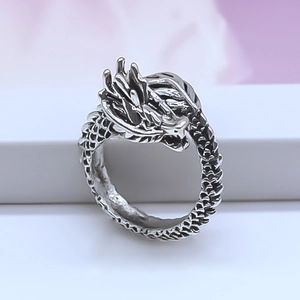 Detailed macro view of vintage dragon ring showing intricate silver scales and texture