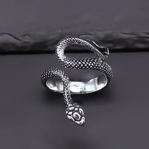 Macro shot of silver snake ring with detailed scale texture and gothic animal design