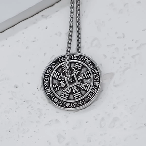 Macro detail of vintage silver Bagua pendant with Chinese zodiac characters and symbols