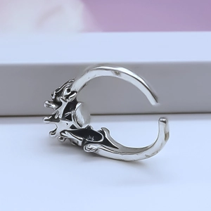 Macro detail of vintage silver crown ring with intricate relief textures and open band