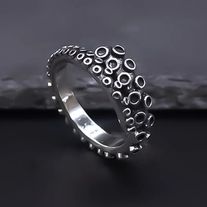 Macro shot of retro silver octopus tentacle ring with detailed suction cup texture