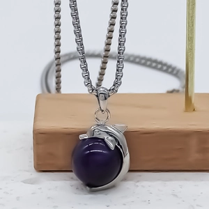 Silver dolphin pendant necklace featuring a purple round gemstone bead with a box chain