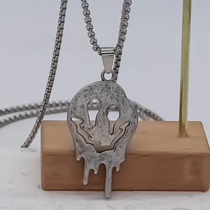 Punk style melted smiley face pendant necklace in silver alloy with box chain design