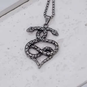 Double snake heart pendant necklace in antique silver with detailed scale texture