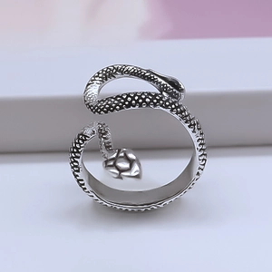 Minimalist silver snake wrap ring with detailed scale texture and spiral design