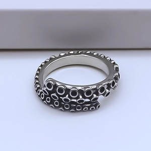 Detailed close-up of retro octopus tentacle ring with oxidized silver suckers
