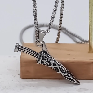 Gothic style silver dagger pendant necklace featuring vintage floral relief and box chain