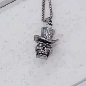 Close-up of vintage silver skull pendant with top hat and durable box chain link