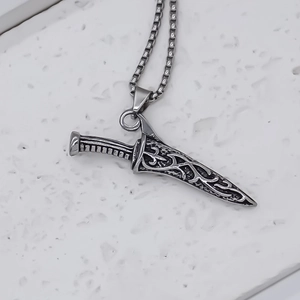 Antique silver dagger pendant necklace with engraved patterns on a sturdy box chain