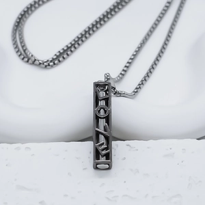 Detail shot of black titanium bar pendant necklace with LOVE cutout lettering design