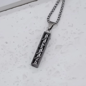 Industrial geometric square pendant necklace with hollow rectangular design on marble