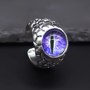 Macro shot of gothic dragon scale ring featuring a mystical purple evil eye gemstone
