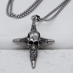 Macro shot of punk cross pendant with skull relief and dark metallic mesh texture