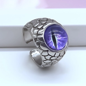 Detail of vintage silver dragon scale ring featuring a mystical purple evil eye gemstone