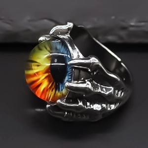 Macro detail of gothic yellow evil eye ring with vintage eagle claw metal texture design