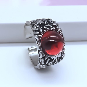 Macro side view of red devil eye ring with irregular silver lava texture and open band