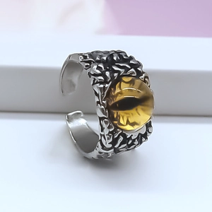 Macro shot of silver-tone dragon eye ring with yellow iris and detailed scale texture