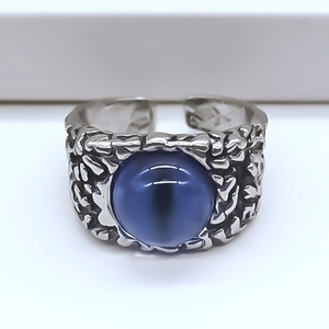 Macro shot of silver textured adjustable ring with a large round blue devil eye stone