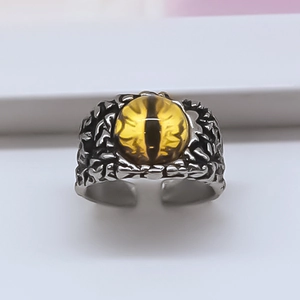 Retro punk adjustable ring featuring a yellow dragon eye gem with textured metal band