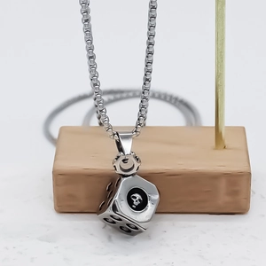 Punk style silver dice pendant necklace featuring skull design on box chain