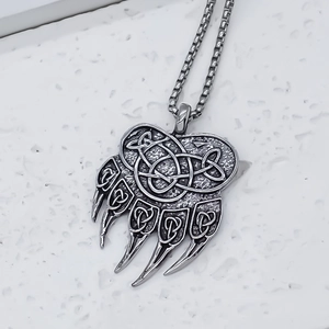 Retro stainless steel bear paw pendant necklace featuring intricate Celtic knot patterns