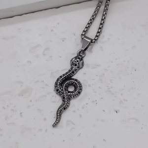 Vintage punk style silver snake pendant necklace with detailed scales on square chain